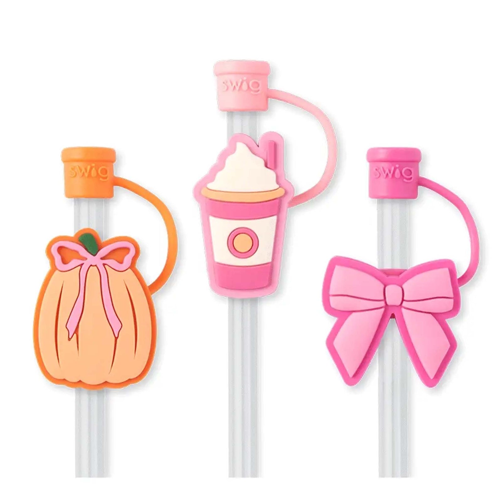 Set of three Swig Life straw toppers shaped like a pumpkin, a pink drink cup, and a pink bow.