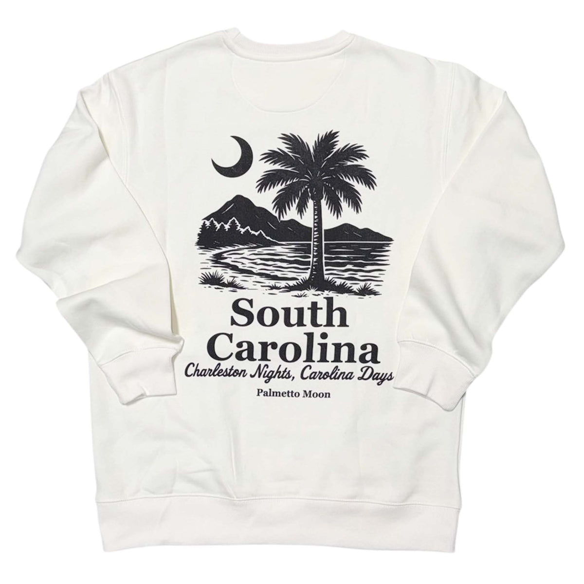 Ivory | Ivory sweatshirt with black graphic design on the back featuring a palm tree, mountains, and text.