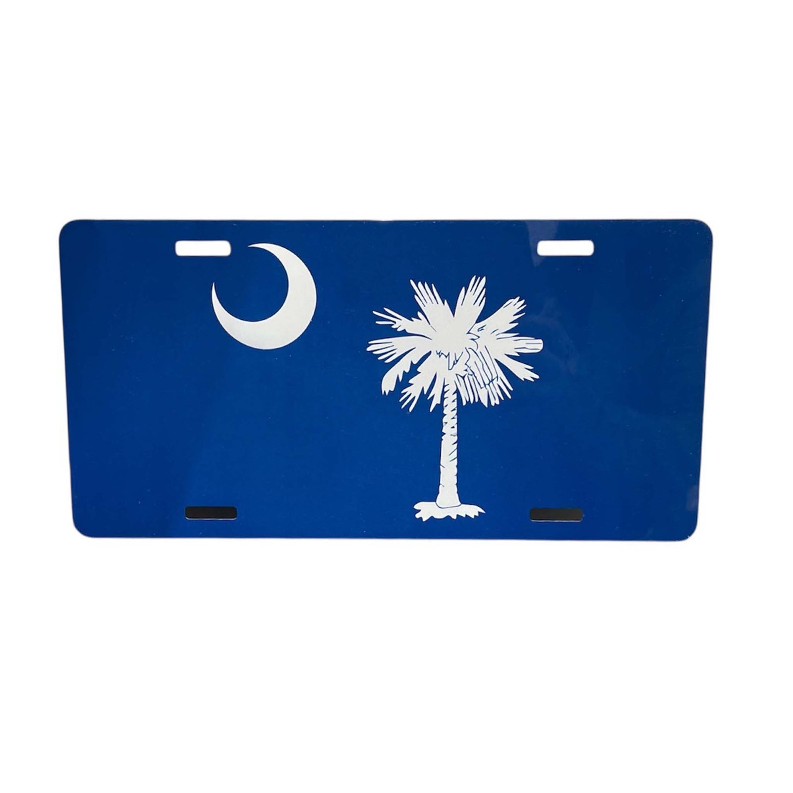 Scent South South Carolina Palm Tree License Plate, color blue, metal.
Blue metal license plate featuring a white crescent moon in the upper left corner and a white palmetto tree on the right, inspired by the South Carolina state flag. The plate includes four pre-drilled mounting holes.
