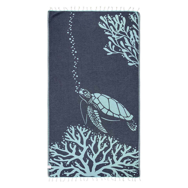 Navy Towel with a sea turtle swimming through coral shown on a white background.