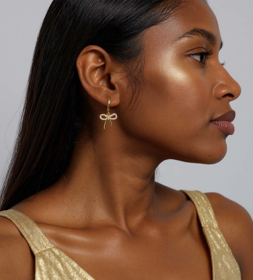 Gold and Diamond Bow Drop Earrings shown on model