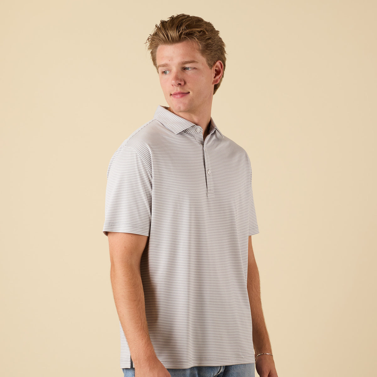 Man wearing a gray striped polo