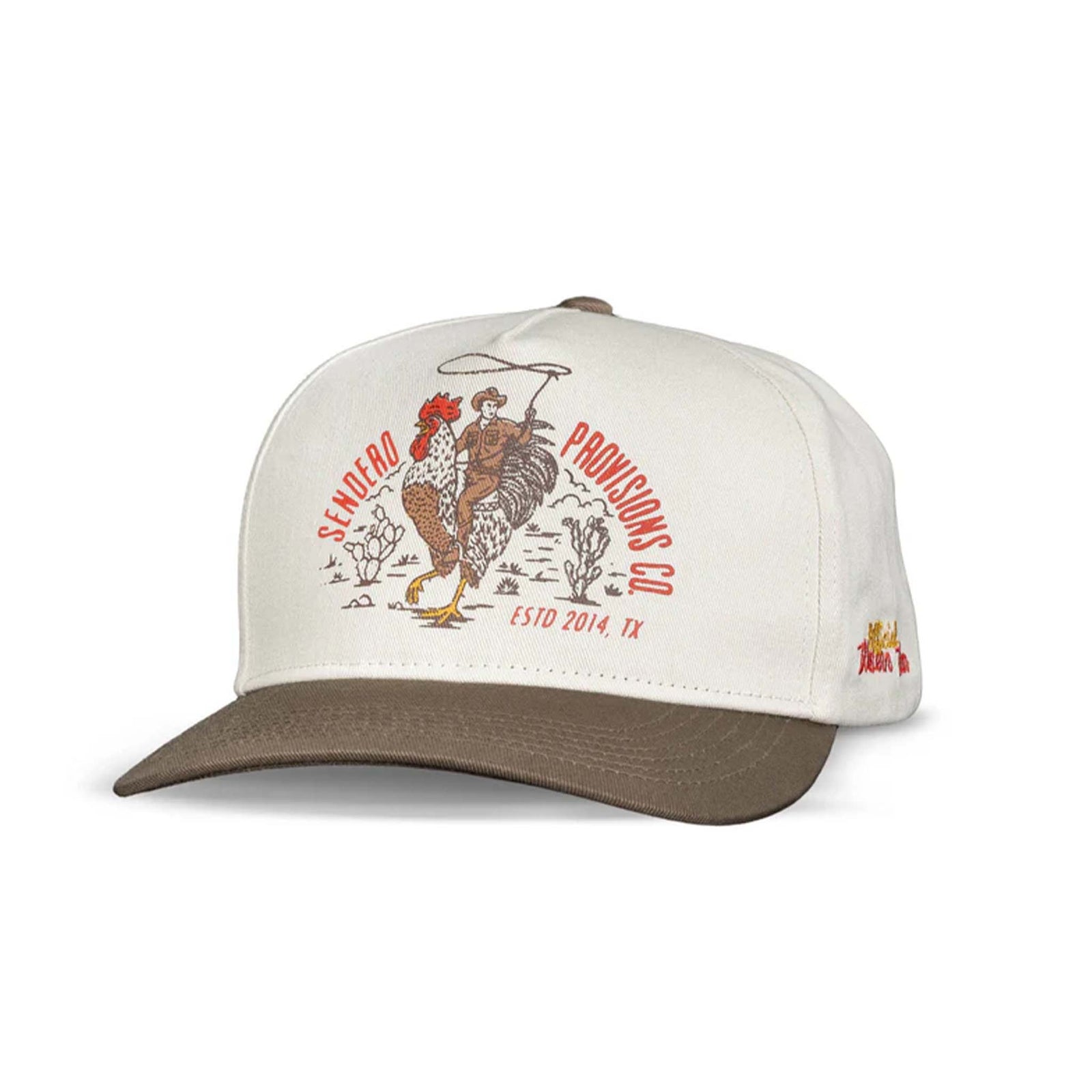 Sendero Provisions Co. cream and brown hat with a cowboy riding a rooster graphic and red embroidered text on front panel. Flat bill with brown brim.