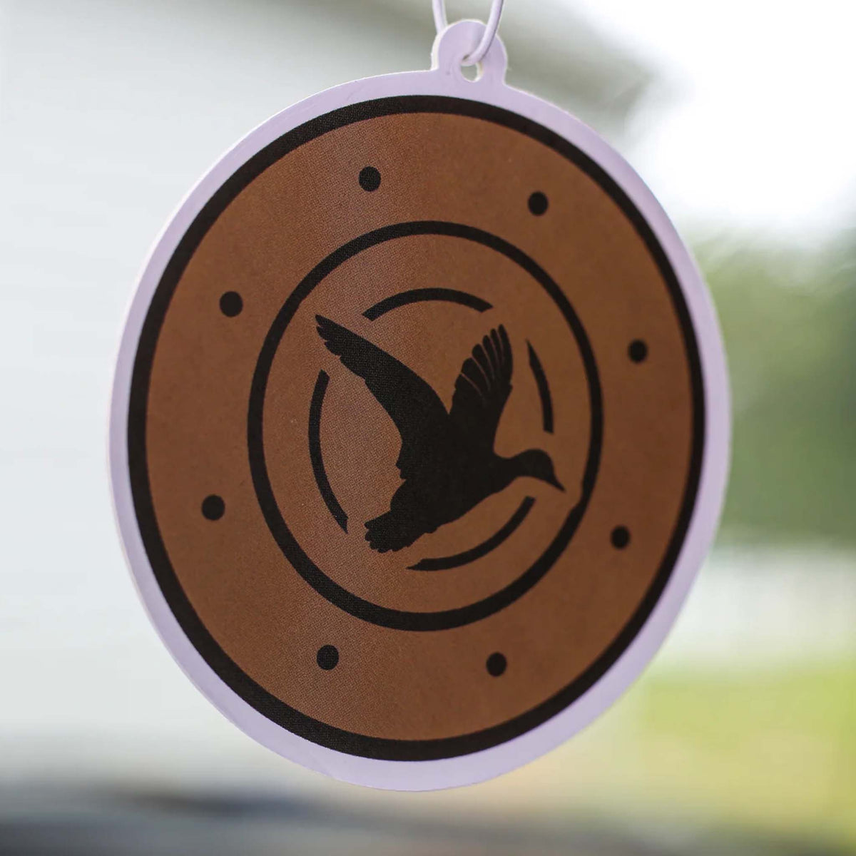 Scent South air freshener shaped like a shotgun shell with black duck silhouette design, hanging from a car mirror.