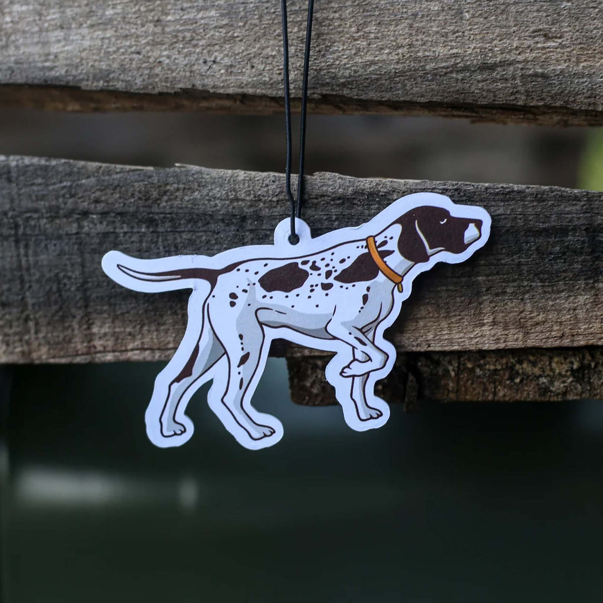 Scent South air freshener shaped like a spotted hunting dog wearing an orange collar, hanging from a string.