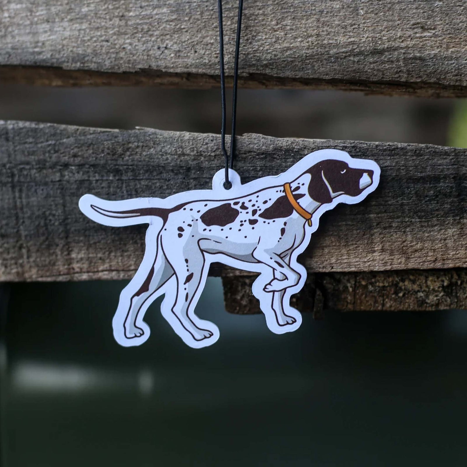 Scent South air freshener shaped like a spotted hunting dog wearing an orange collar, hanging from a string.