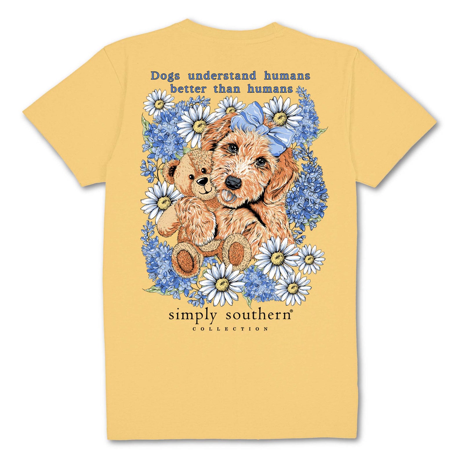 Simply Southern Youth Dog and Teddy Short Sleeve T-shirt, color yellow, youth sizes S-L, 100% cotton, unisex sizing.
Yellow short sleeve shirt with the phrase 'Dogs understand humans better than humans' and a dog holding a teddy bear in a bed of blue and white flowers. Simply Southern logo below and on left chest.
