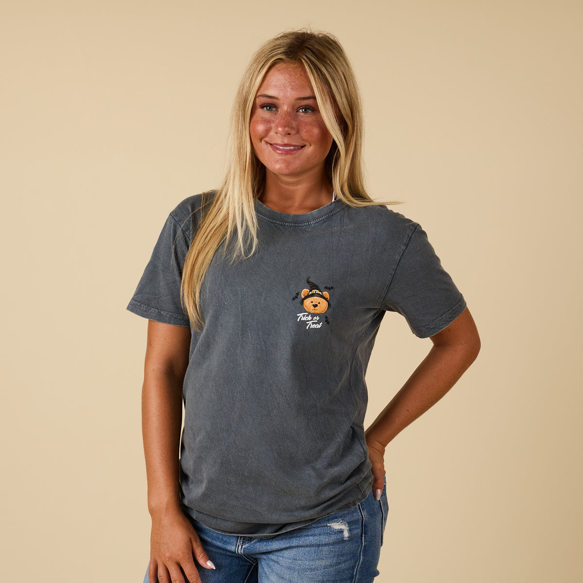 Front view of washed coal Simply Southern short sleeve tee with small teddy bear holding pumpkin candy bucket and “Trick or Treat” text on chest.