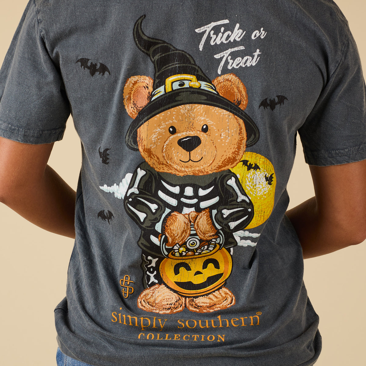 Close-up of teddy bear Halloween graphic on back of washed coal Simply Southern tee with bats and moon details.