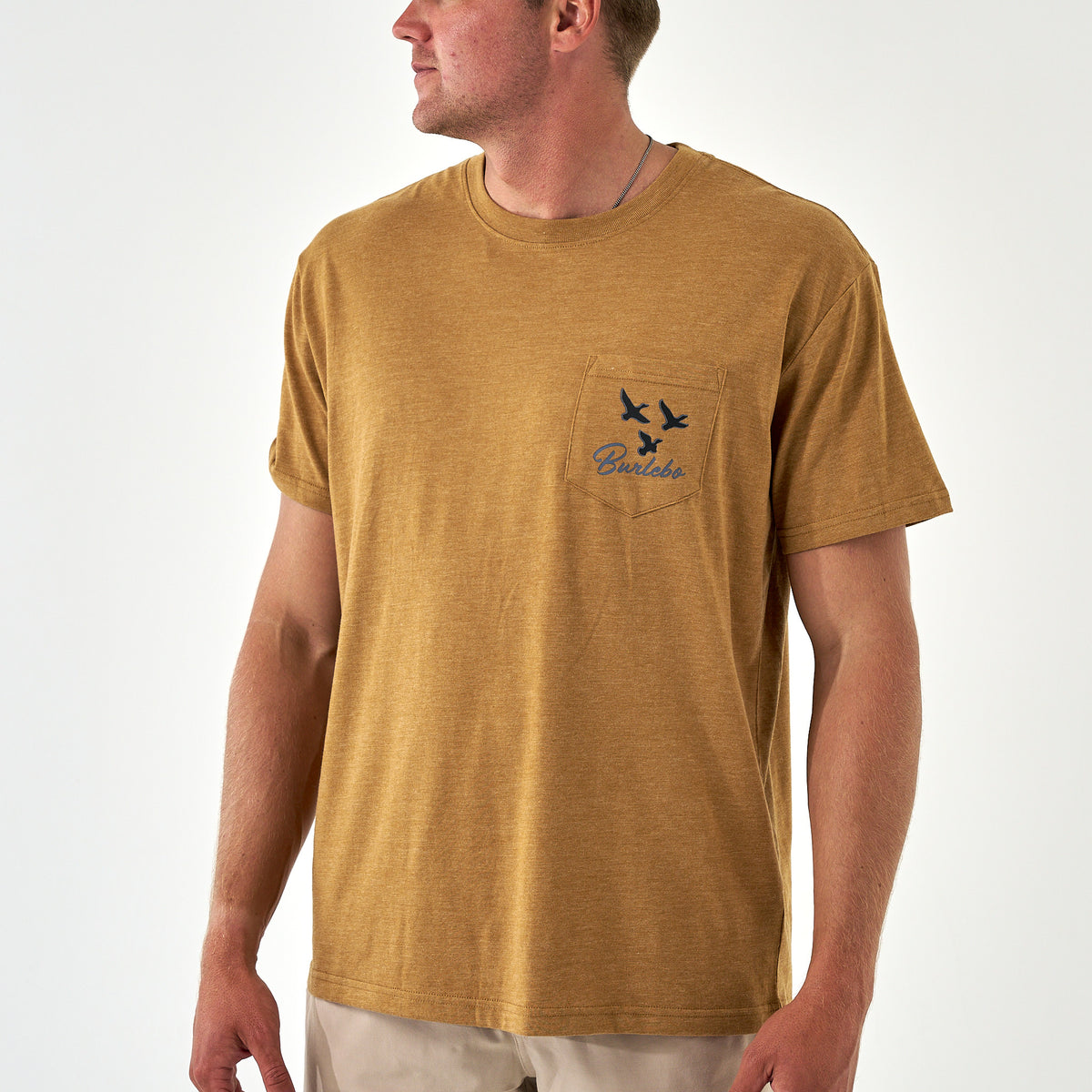 Front view of light brown Burlebo short sleeve pocket tee with flying ducks and logo.