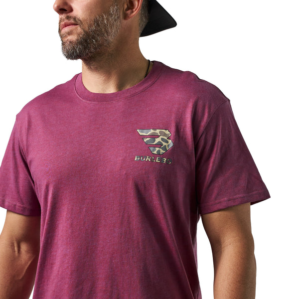 Close-up of a male model wearing a heather maroon short sleeve Burlebo t-shirt with a small camouflage Burlebo logo printed on the chest.