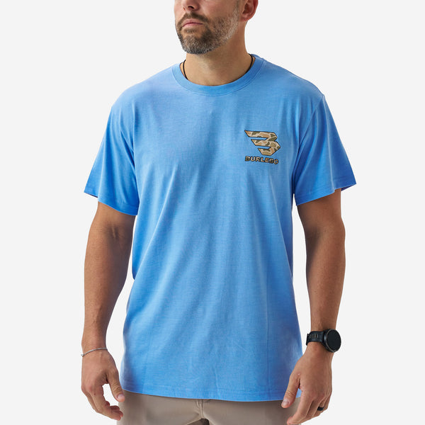 Front view of a male model wearing a bright blue short sleeve Burlebo t-shirt with a small camouflage Burlebo logo on the chest.