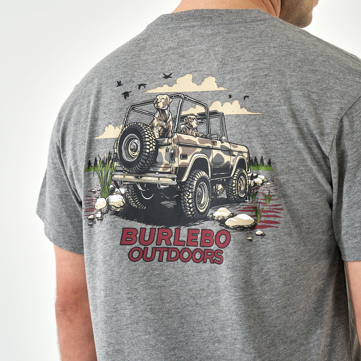 Close-up of large jeep and dogs graphic with “Burlebo Outdoors” text on gray t-shirt back.
