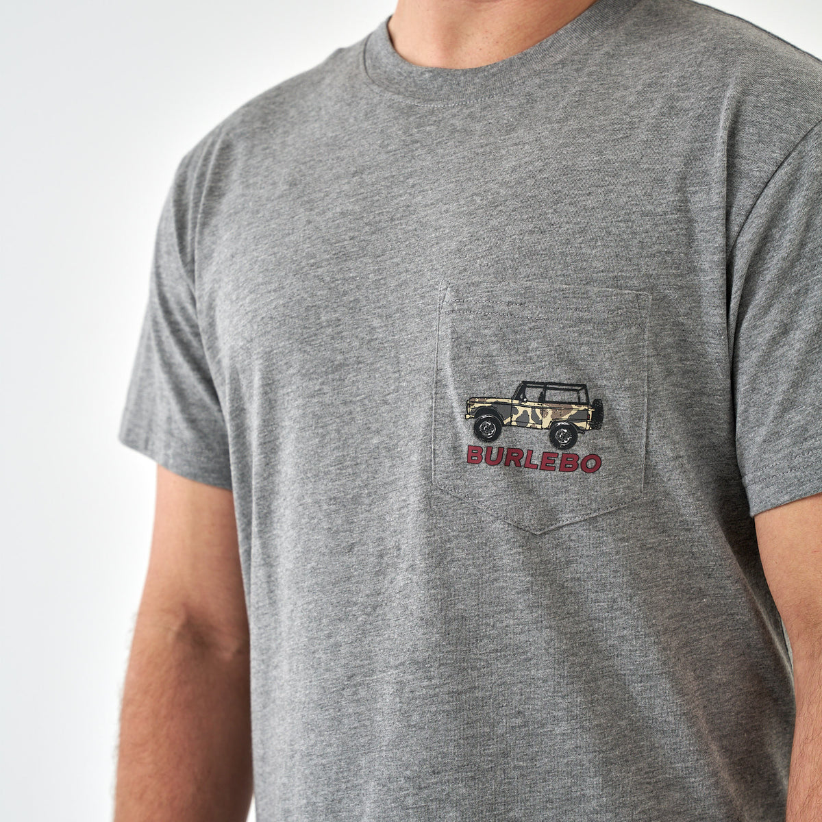Close-up of gray pocket t-shirt with small camo jeep and red “Burlebo” text on left chest.