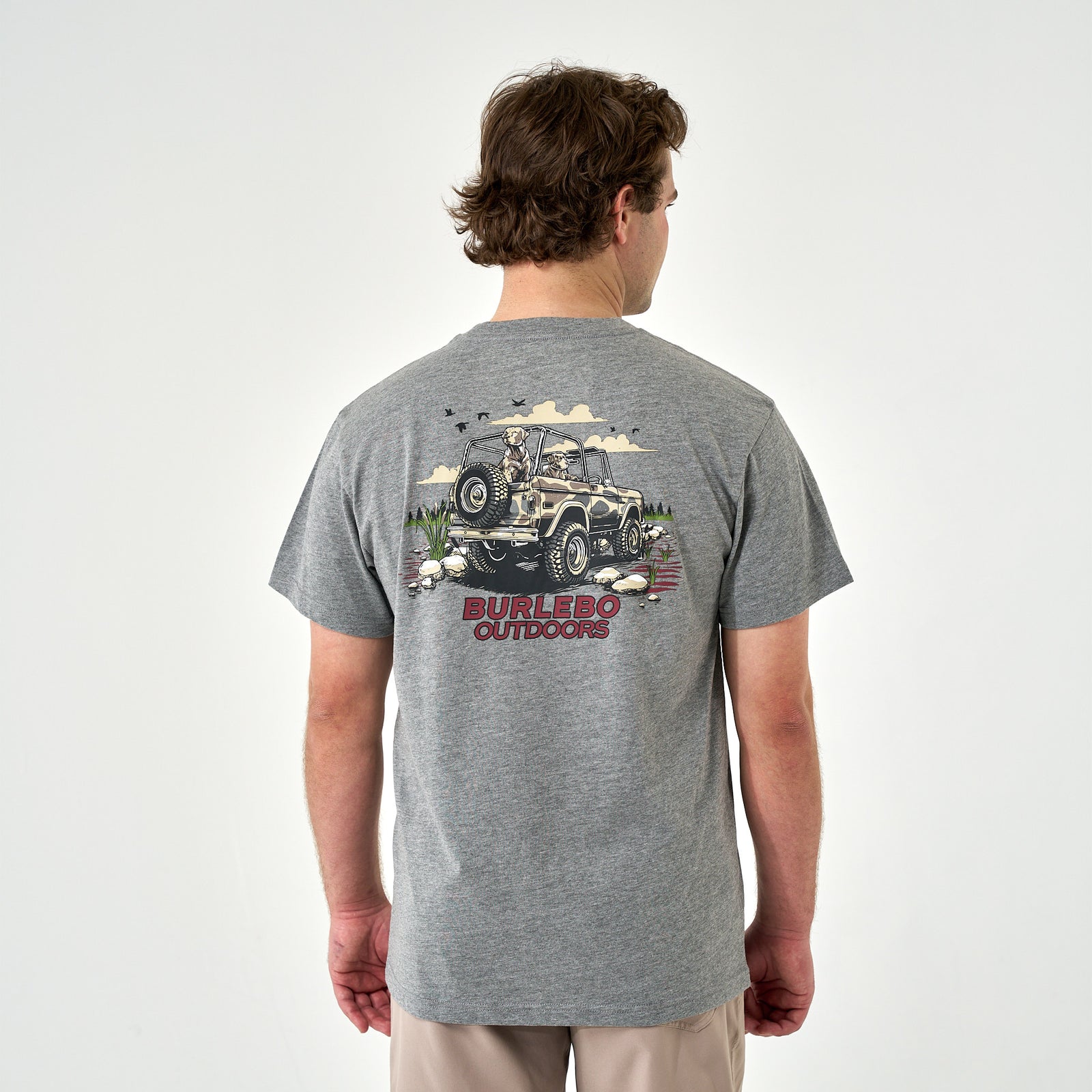 Back view of gray t-shirt with large jeep and dogs graphic, red “Burlebo Outdoors” text.