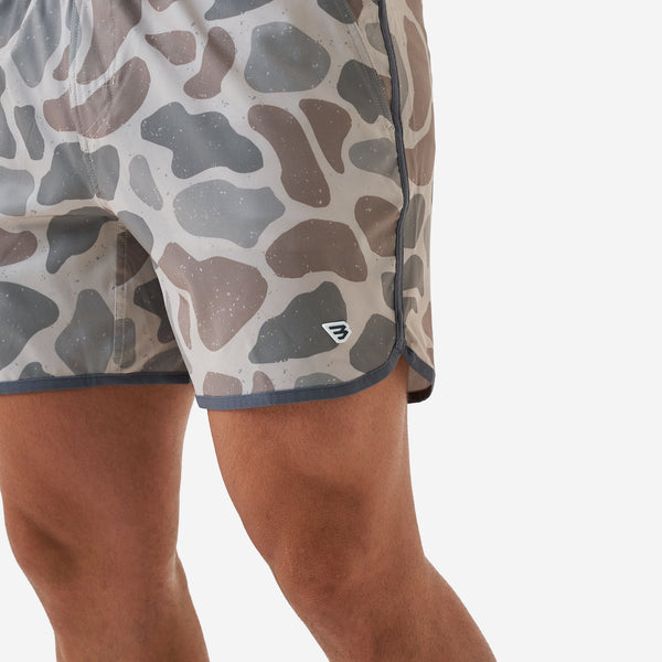 Burlebo 5 Inch Swim Shorts in Jumbo Deer Camo worn by a man in front of a white backdrop