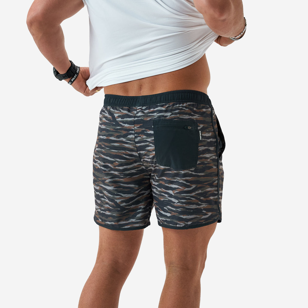 Man wearing Burlebo 5 Inch Lined Swim Shorts in Tiger Wetland camo pattern on a white backdrop.