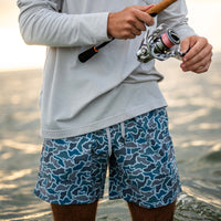 Guy fishing in Local Boy swim trunks.