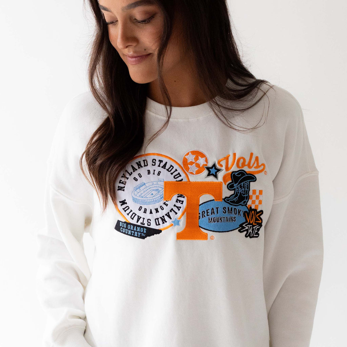 White Tennessee Volunteers sweatshirt with multicolor front graphics featuring Power T, Neyland Stadium, and Smoky Mountain designs, front view.