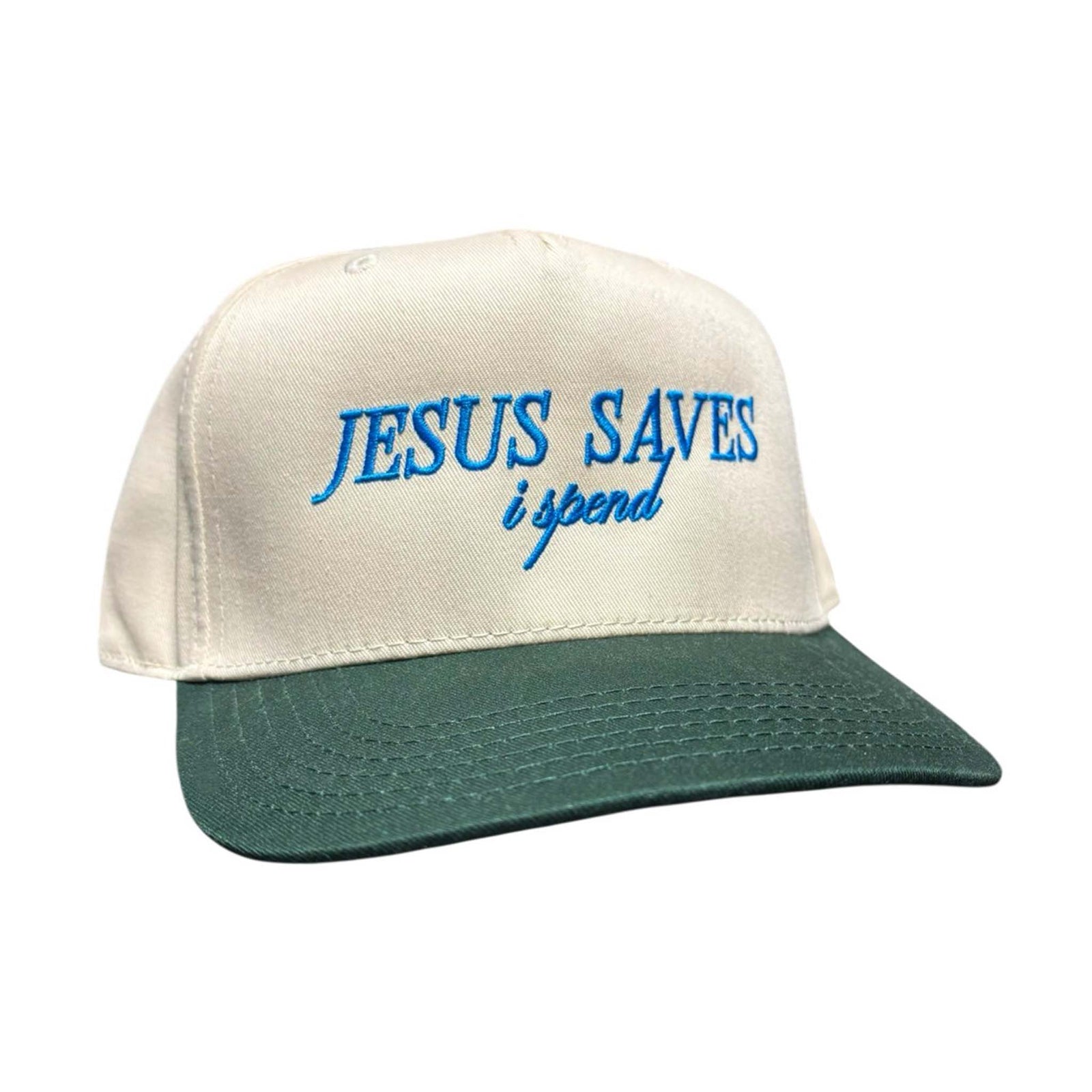 The Happiest cream hat with green brim featuring cobalt blue embroidered text that reads “Jesus Saves, I Spend.”