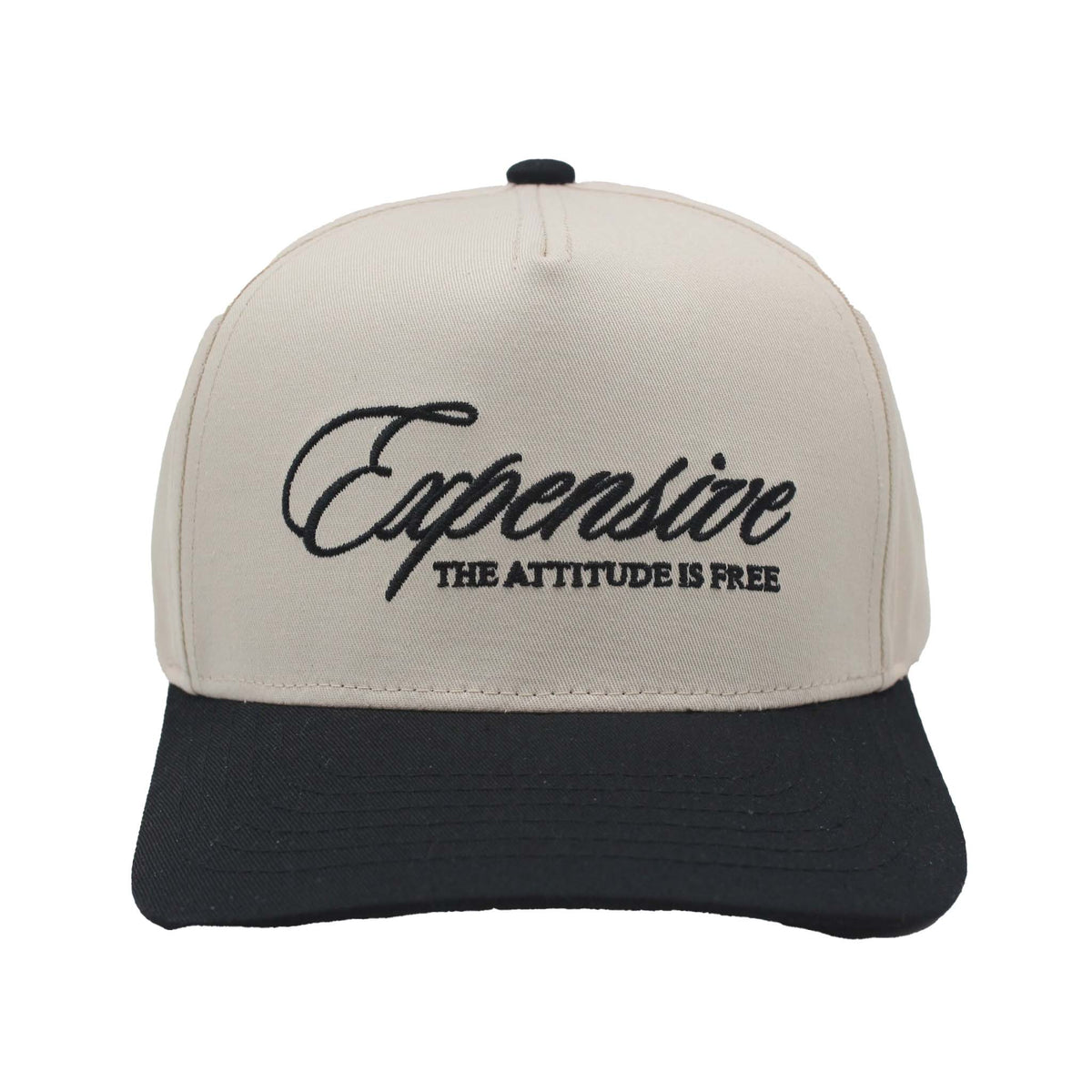 Two-tone trucker hat with natural crown and black bill featuring embroidered text 'Expensive – The Attitude Is Free' on the front panel.