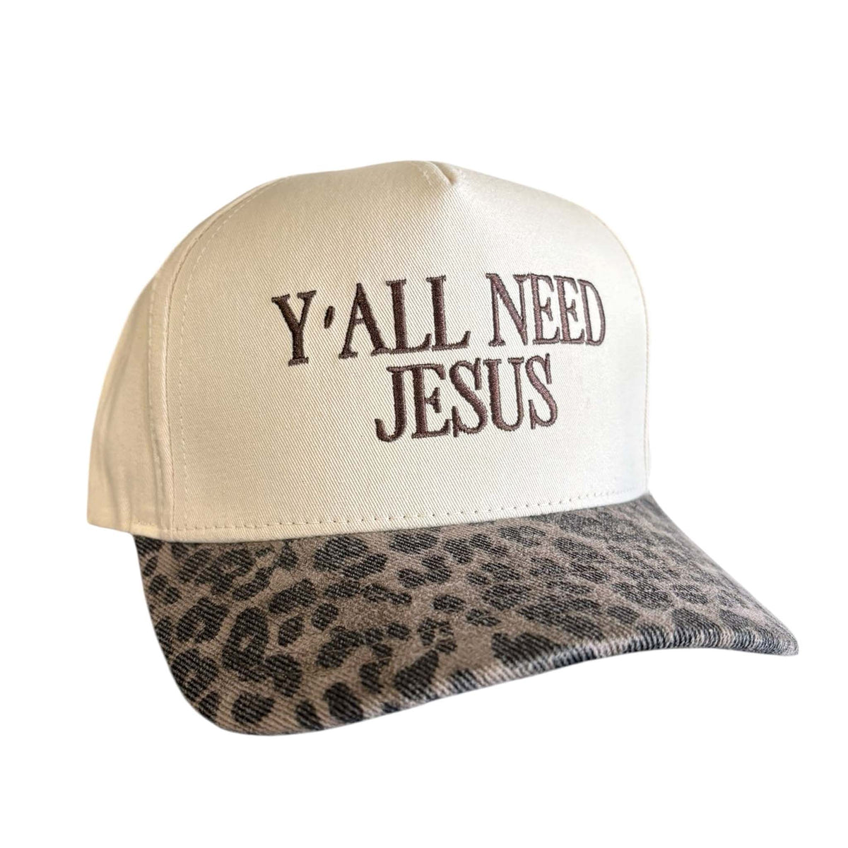 beige trucker hat with embroidered 'Y’all Need Jesus' text and leopard print bill.