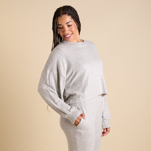 Woman wearing a grey hacci lounge set.
