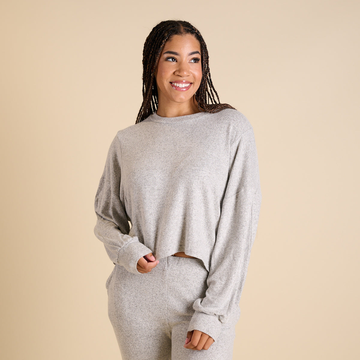 Woman wearing a grey hacci lounge set.