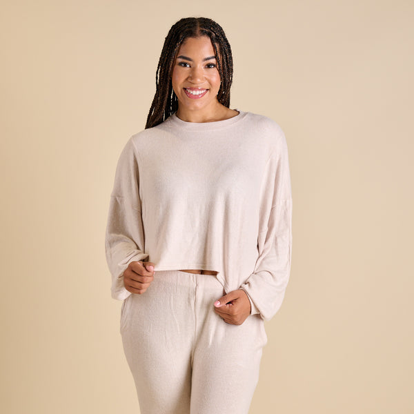 Woman wearing an oatmeal hacci lounge set.