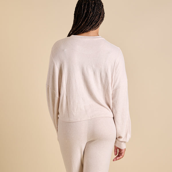 Woman wearing an oatmeal hacci lounge set.