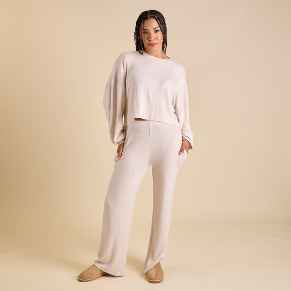 Woman wearing an oatmeal hacci lounge set.