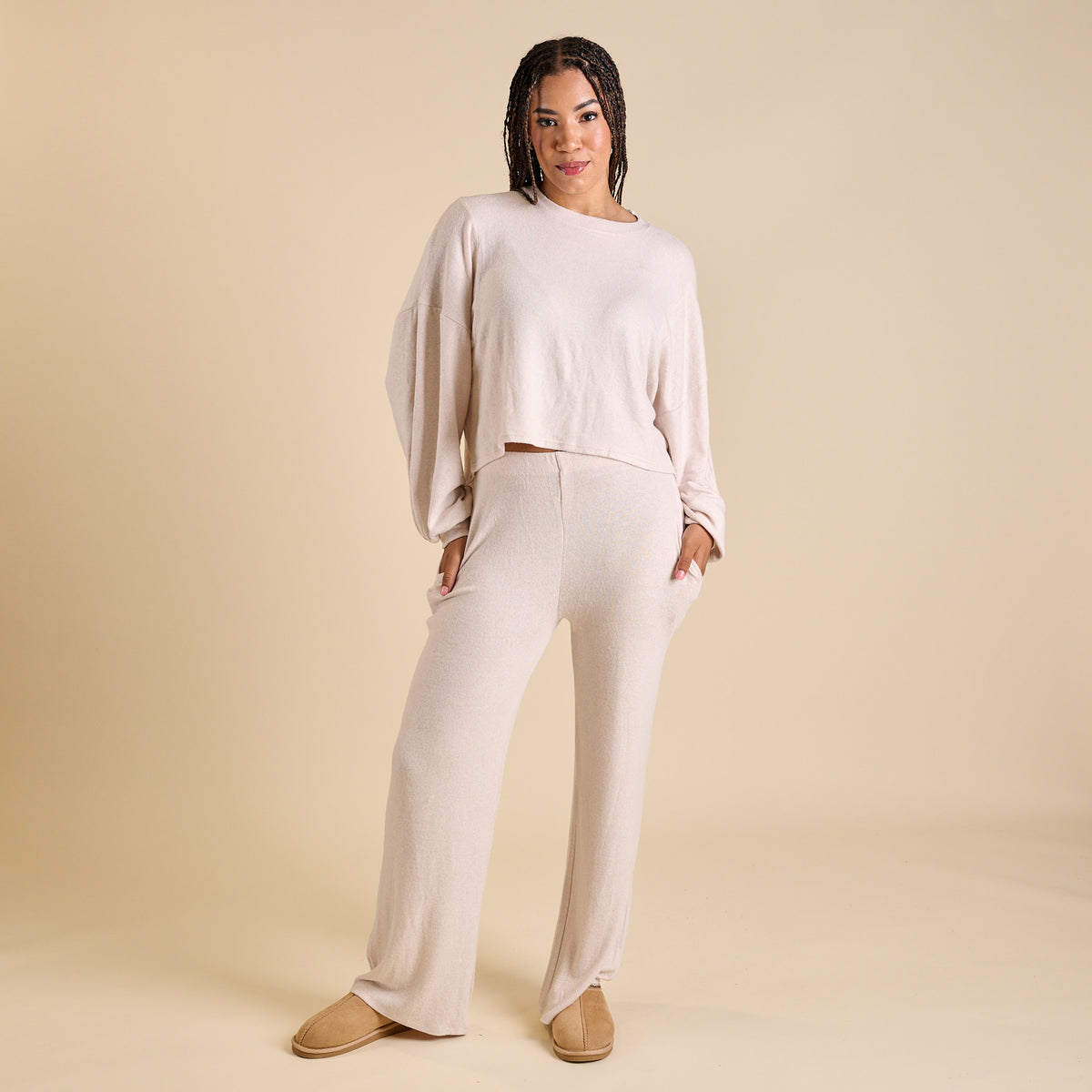 Woman wearing an oatmeal hacci lounge set.