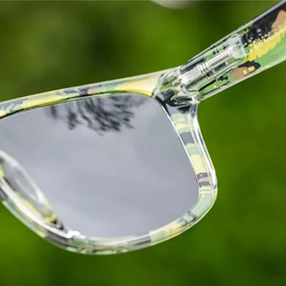 Sunglasses with floral patterned arms on a blurred green background