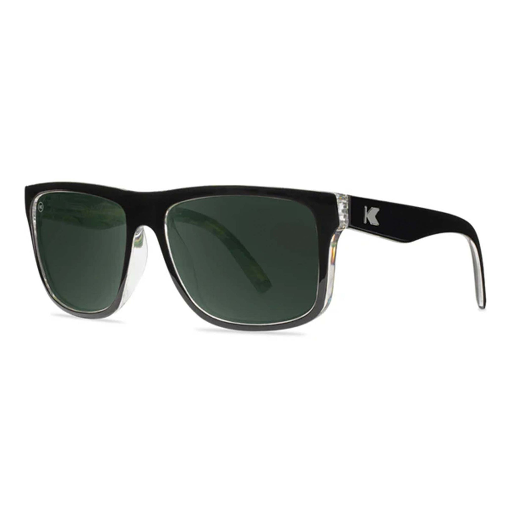 Black sunglasses with green lenses on a white background