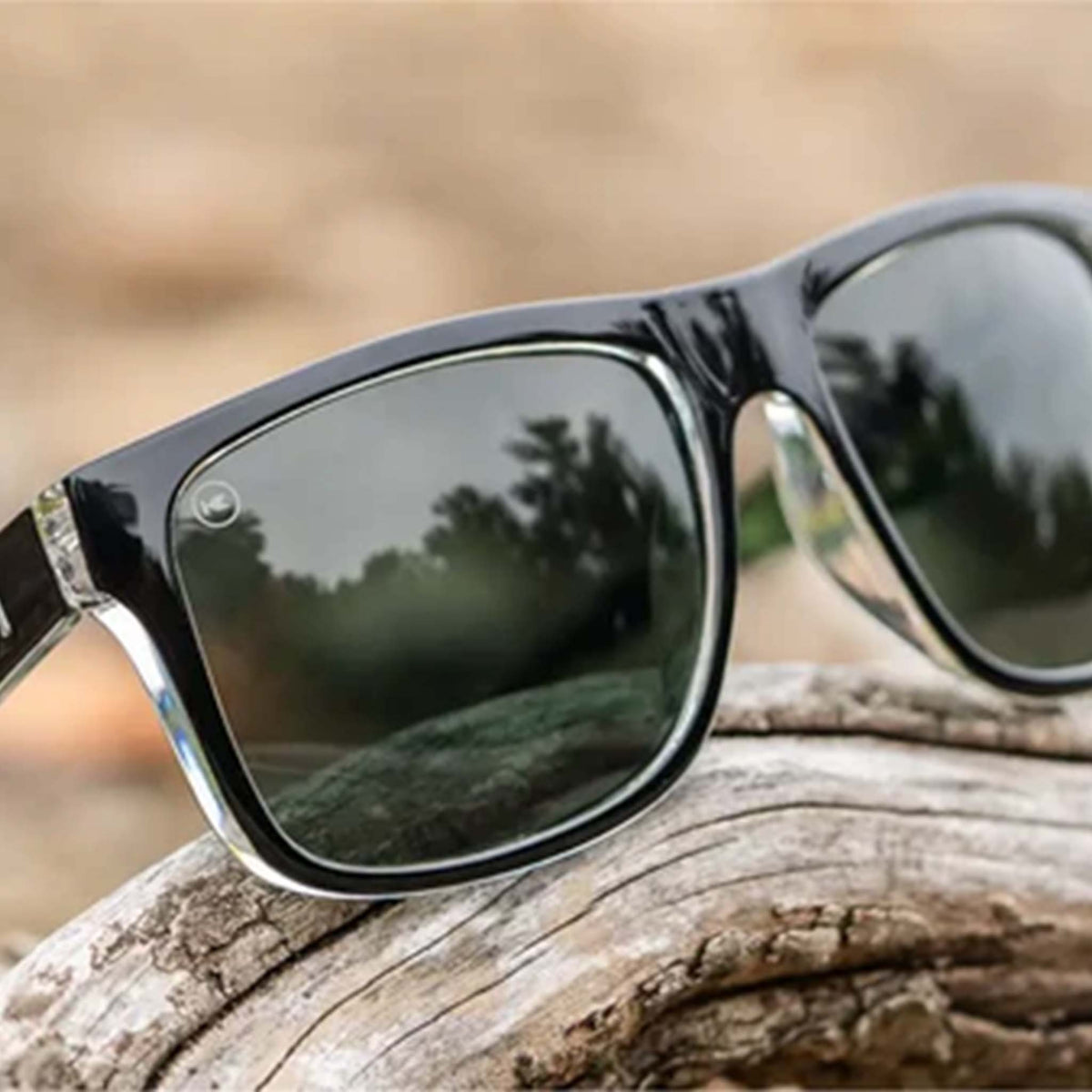 Sunglasses with reflective lenses on a wooden surface