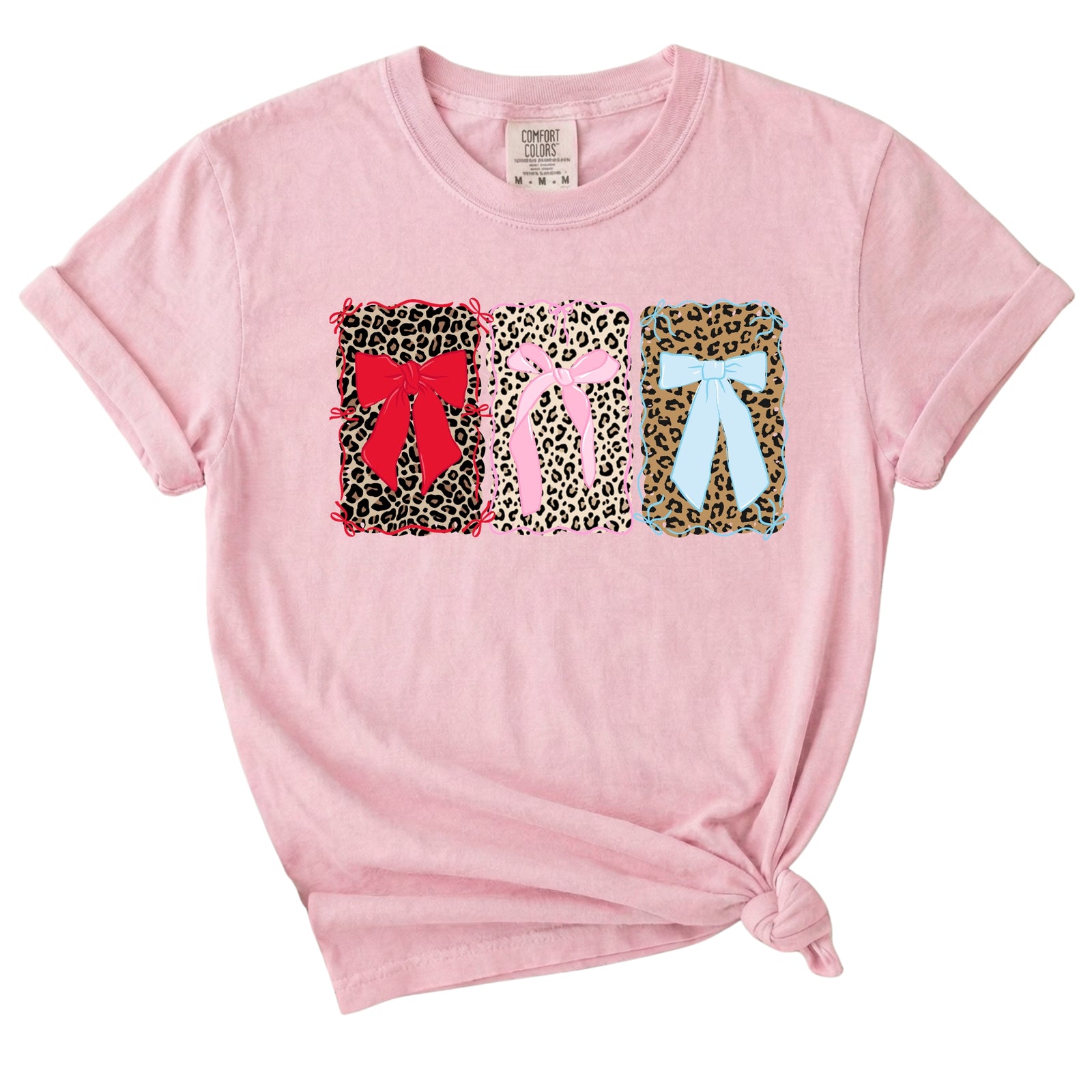 Pink t-shirt with colorful bow designs on a white background