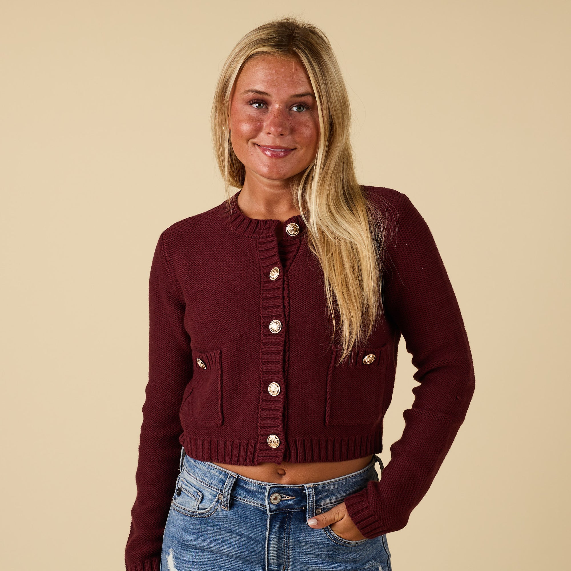 Front view of redwood cropped cardigan sweater with gold-tone button closure and patch pockets.