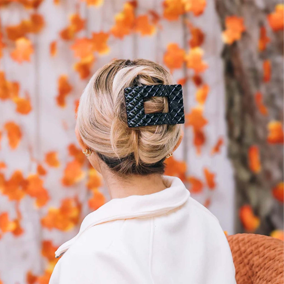 Teleties Quilted Large Flat Rectangle Hair Clip in Jet Black, lifestyle image holding blonde hair in a French twist style.