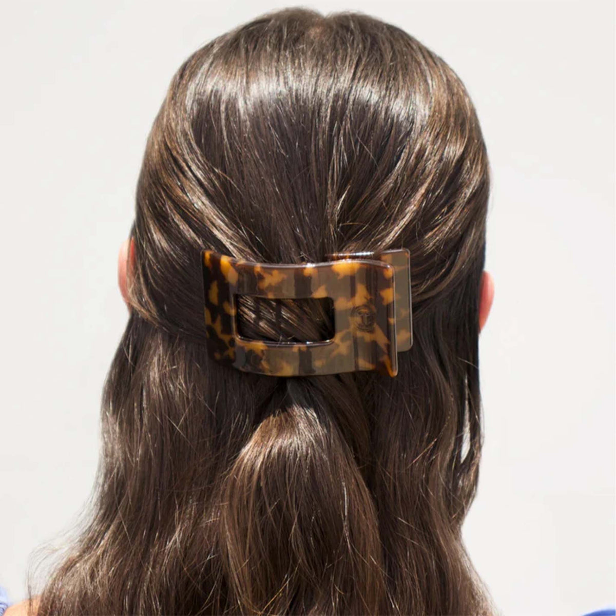 Small Flat Rectangle Hair Clip in Tortoise styled in brunette hair, securing a half-up hairstyle.