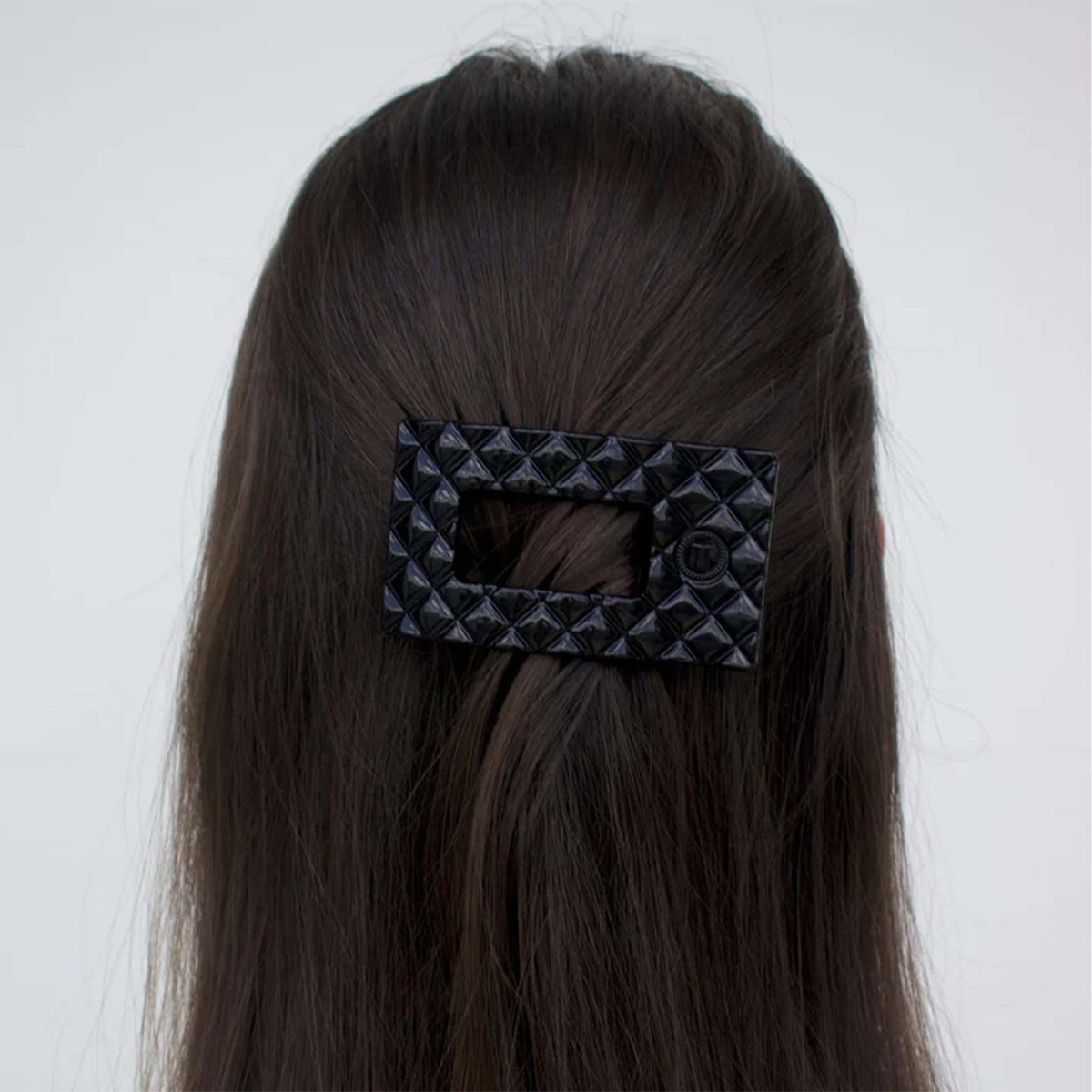 Small Flat Rectangle Hair Clip in Jet Black styled in brunette hair, securing a half-up hairstyle.