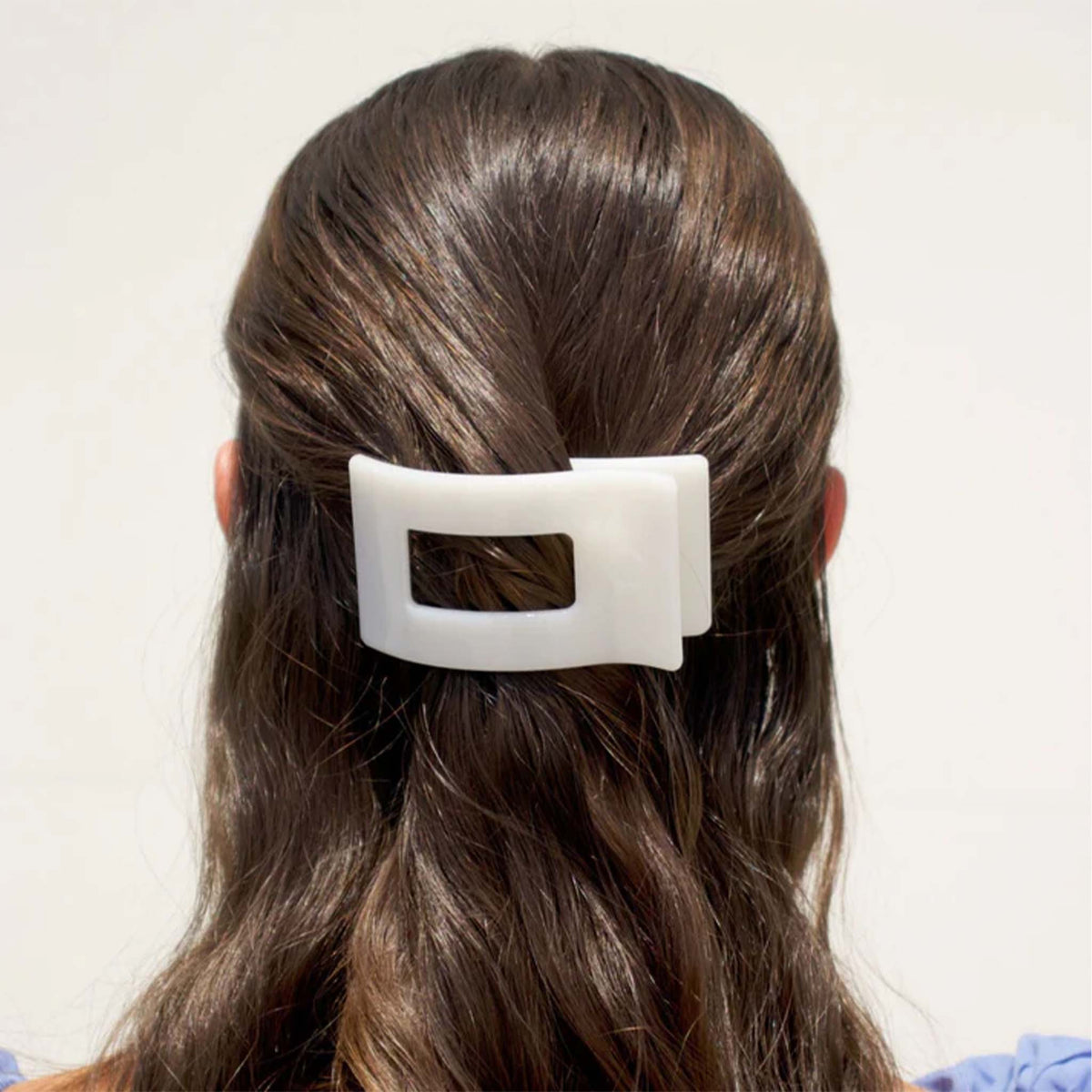 Small Flat Rectangle Hair Clip in Coconut securing half-up hairstyle on brunette model.