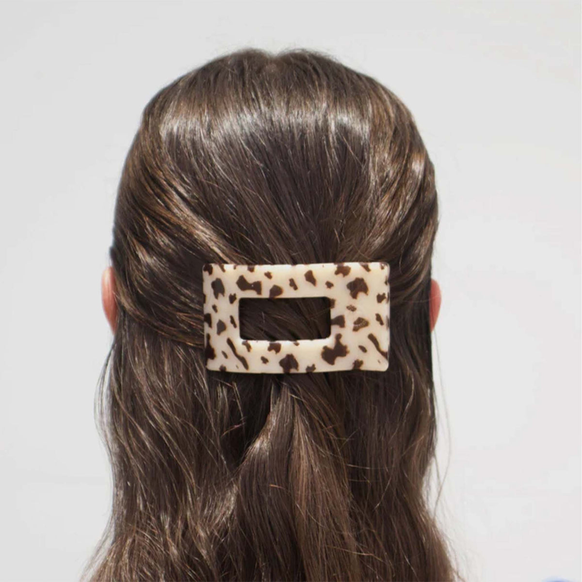 Small Flat Rectangle Hair Clip in Blonde Tortoise securing half-up hairstyle on brunette model.