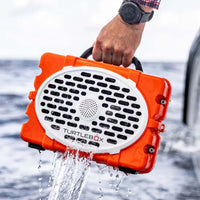 Guy holding a Turtlebox after taking it out of water.