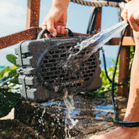 Someone hosing off a Turtlebox speaker.