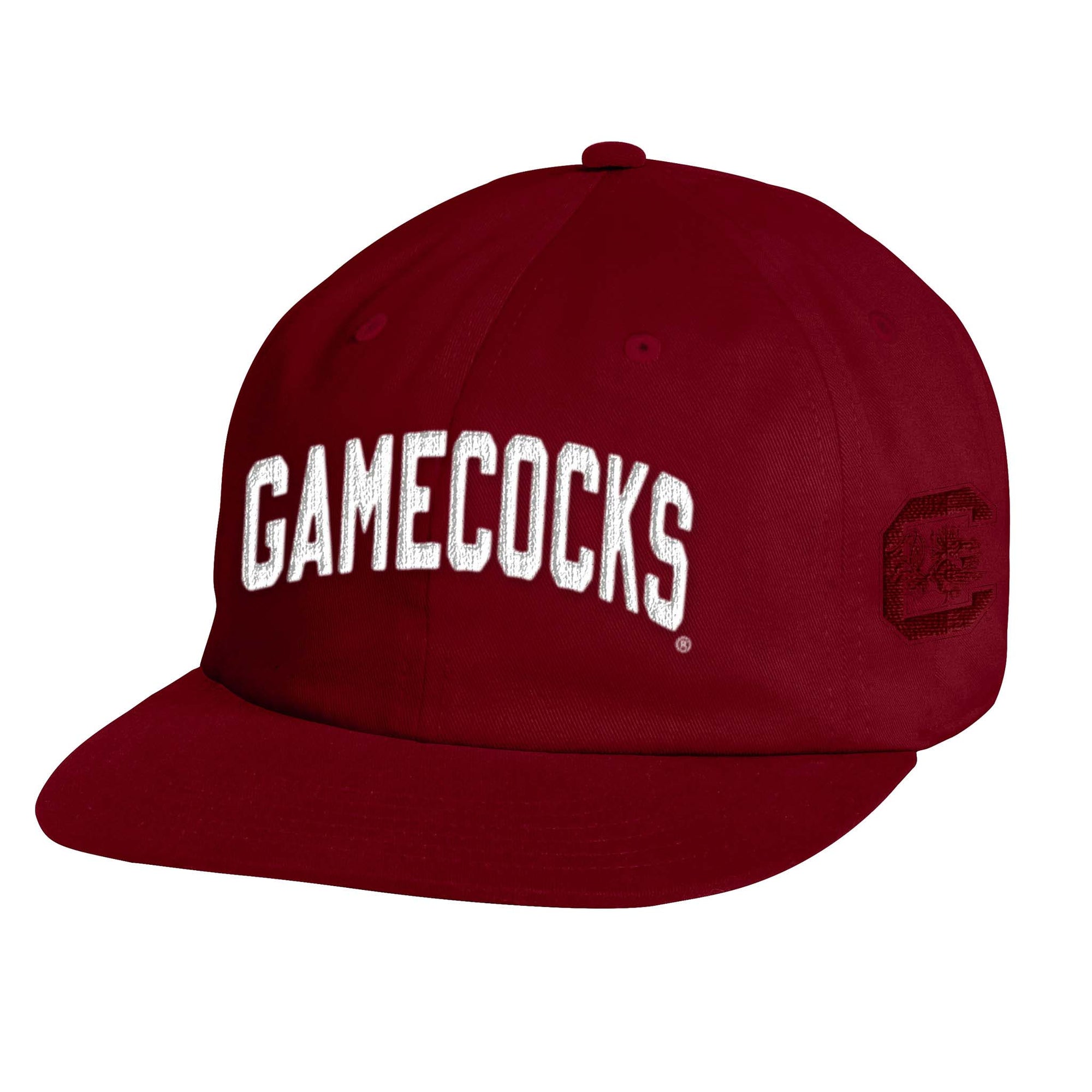 Front angled view of cardinal red Gamecocks Under Armour hat with white embroidered “Gamecocks” text and Block C logo on side.