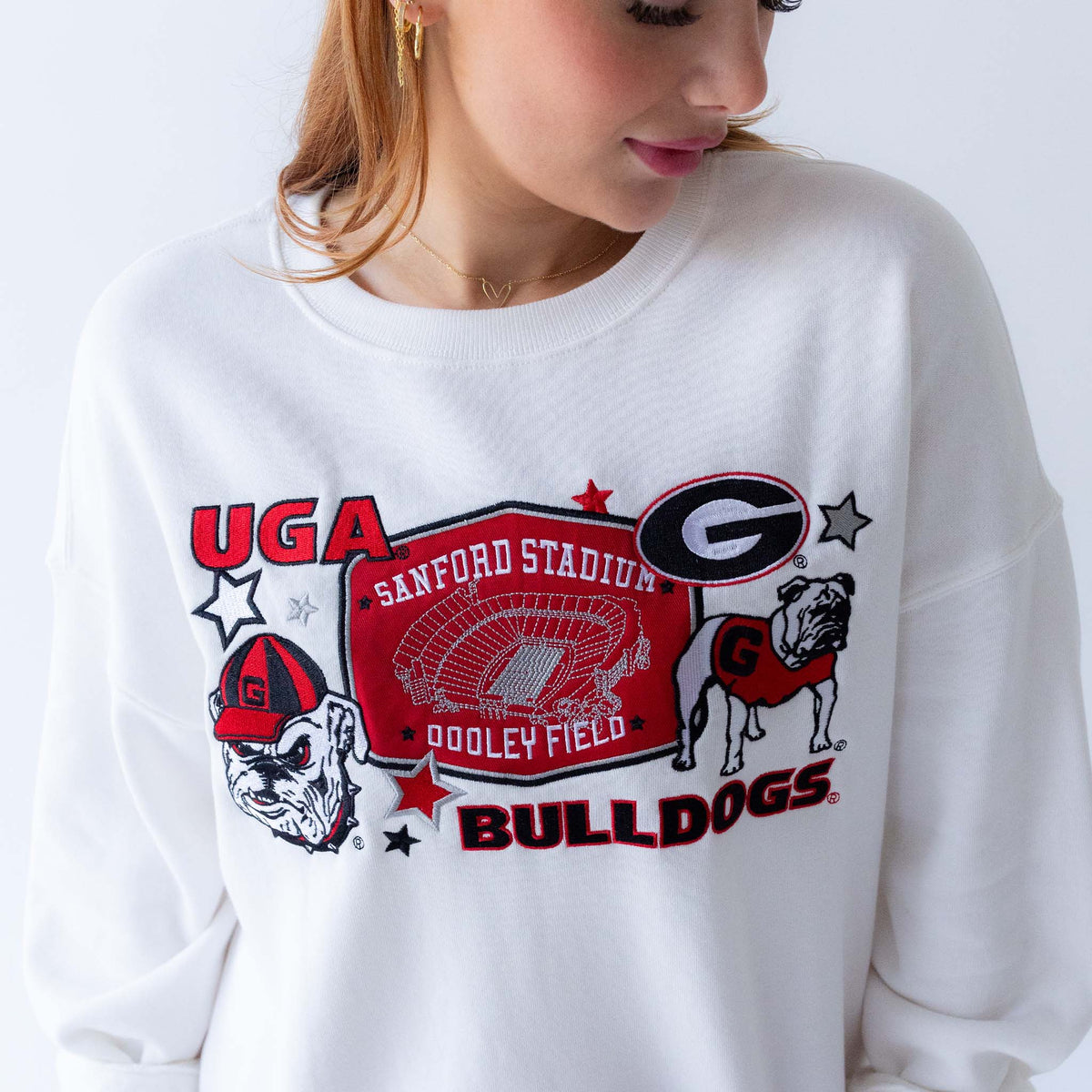 White University of Georgia crewneck sweatshirt with large front graphic featuring Sanford Stadium, UGA mascot, and Bulldogs logo.