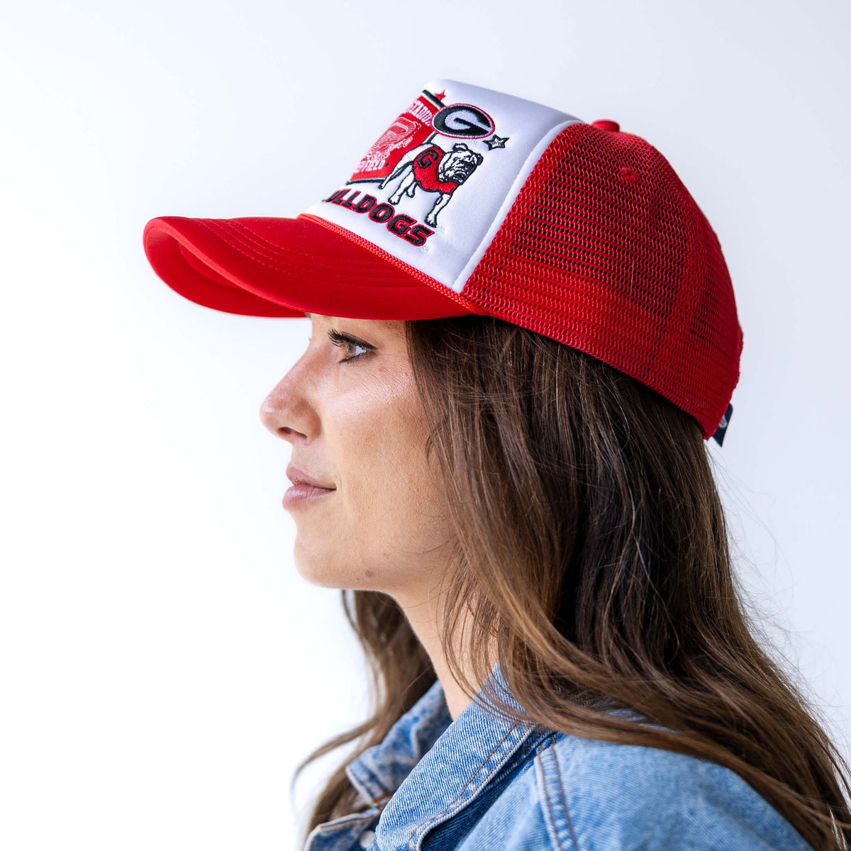Profile of red and white Georgia Bulldogs trucker hat with mesh back and adjustable snapback closure.