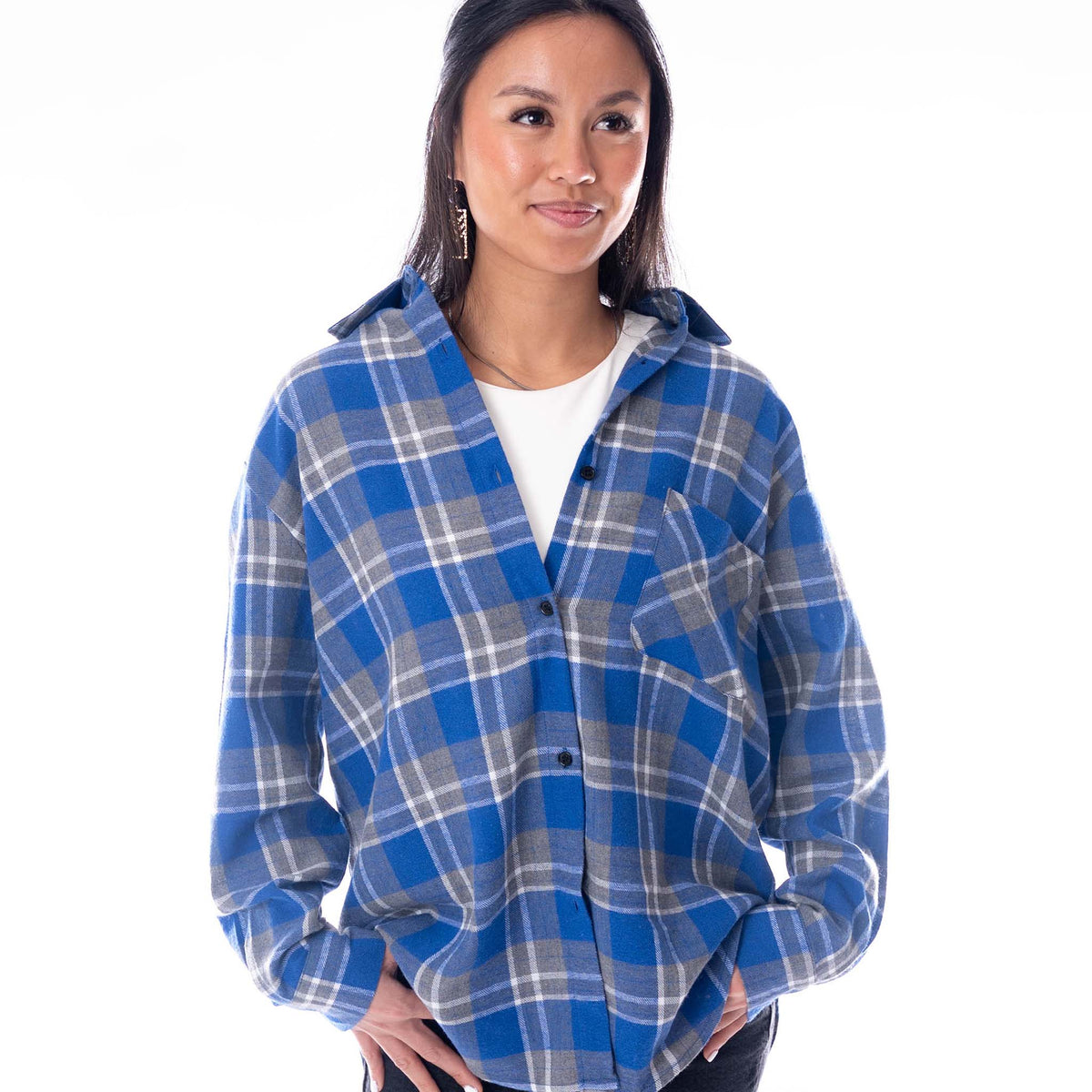 Front view of a woman wearing a blue and grey plaid Kentucky Wildcats flannel shirt with an oversized fit and chest pocket.