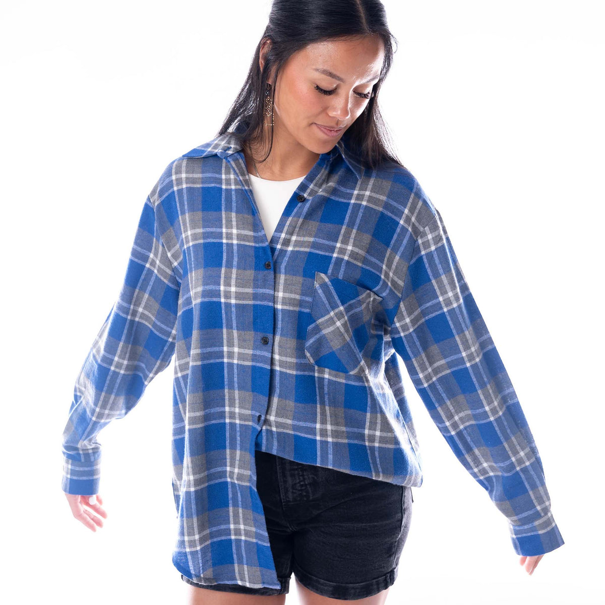 Side view of a woman wearing a blue and grey plaid Kentucky Wildcats flannel shirt with button-front closure.