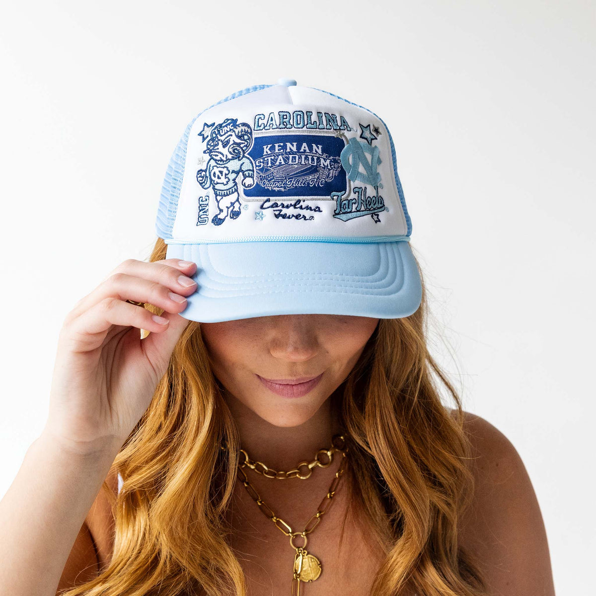 Person wearing a blue and white cap with text and graphics on a white background